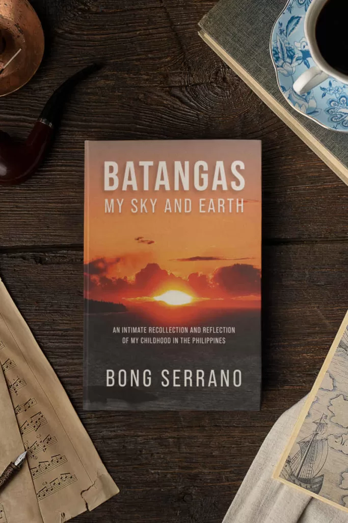 Copy of Batangas: My Sky and Earth on a wooden table surrounded by vintage objects