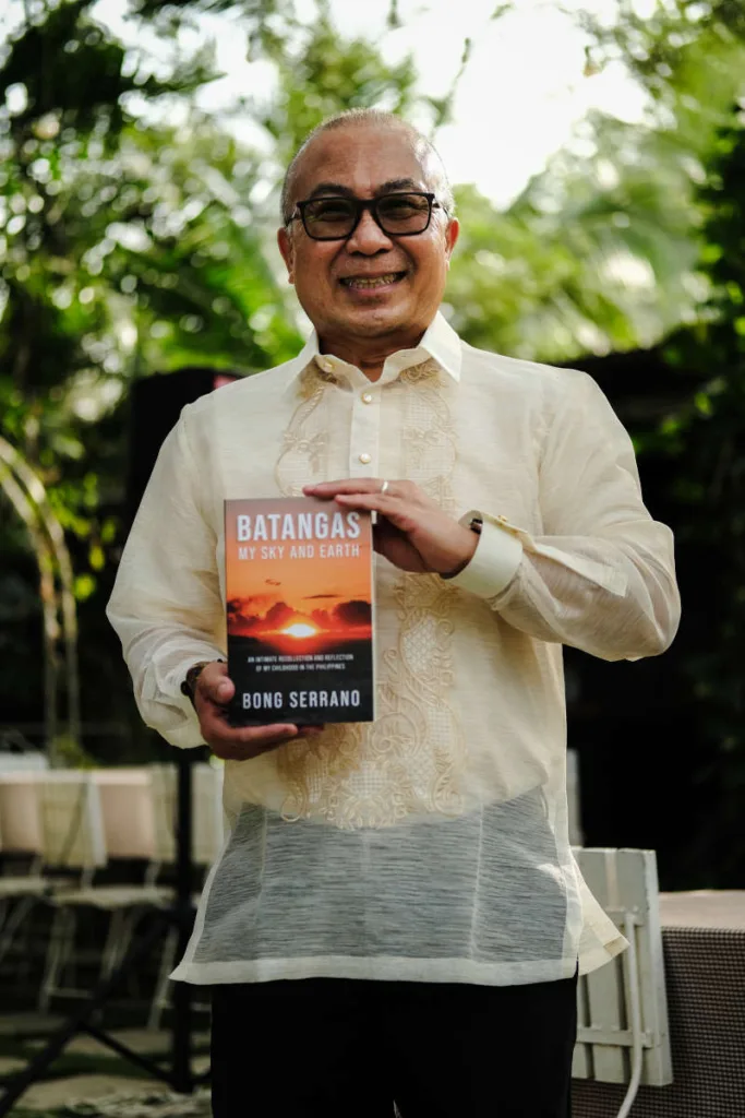 The author, Bong Serrano, holding the paperback edition of the book, Batangas: My Sky and Earth