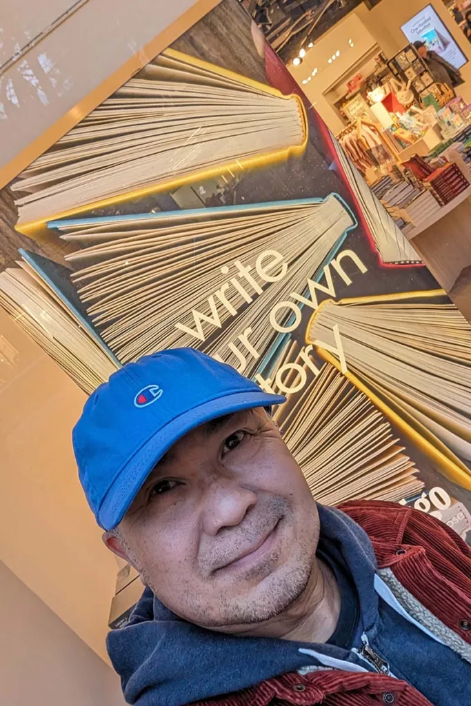Bong Serrano in front of Indigo Robson's "write your own story" window display